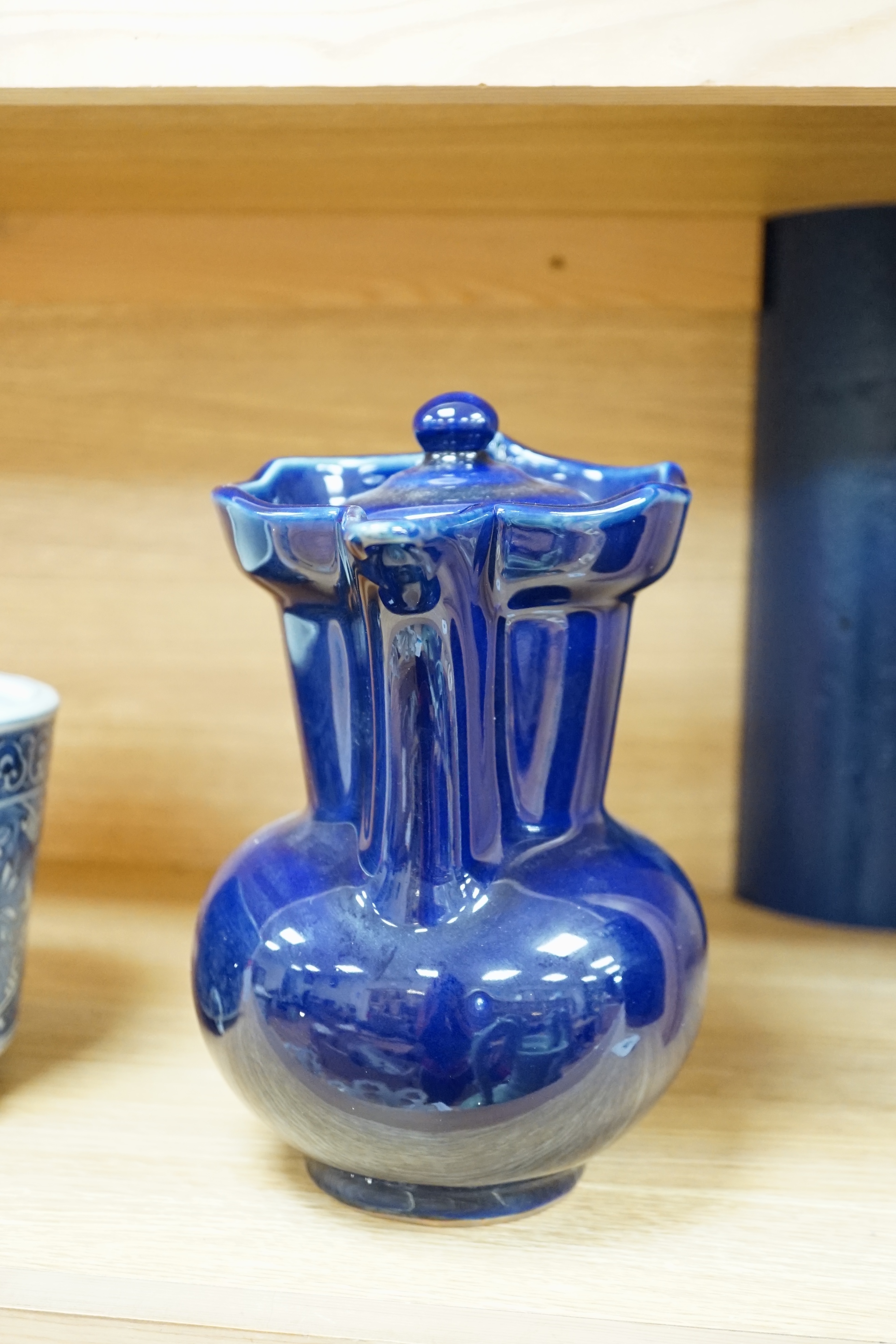 A Chinese dark blue glazed ewer and cover, 23cm high. Condition - good